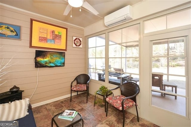 sunroom with a wall unit AC and ceiling fan