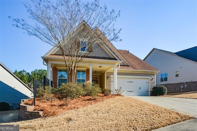 craftsman-style house with an attached garage and driveway