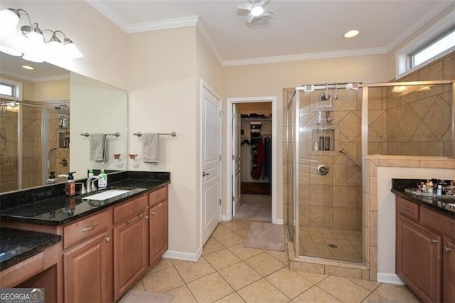 bathroom with tile patterned flooring, a stall shower, vanity, and ornamental molding