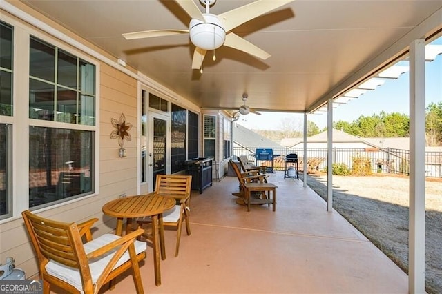 view of patio featuring ceiling fan and fence