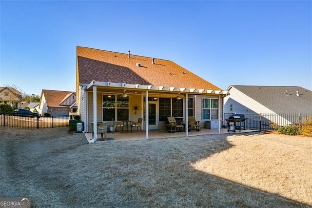 rear view of property featuring a patio area and a fenced backyard