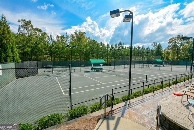 view of tennis court featuring fence