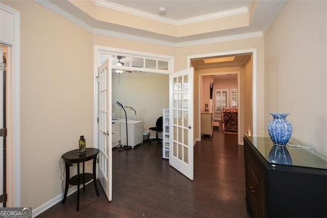 corridor featuring dark wood-style floors, french doors, a raised ceiling, and ornamental molding