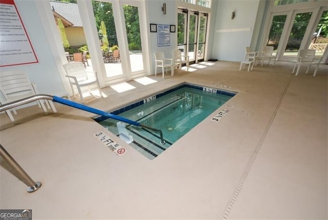 view of pool featuring french doors