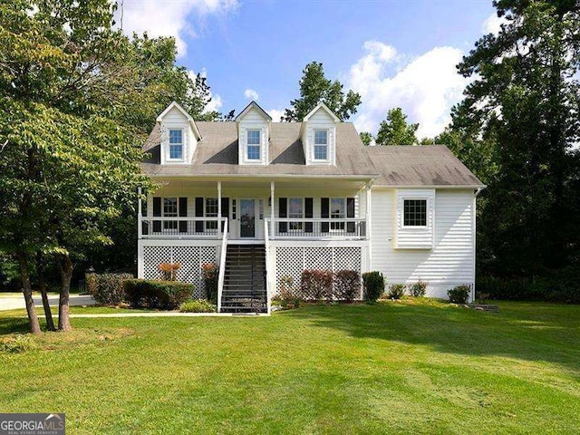 view of front facade featuring stairway, covered porch, and a front yard