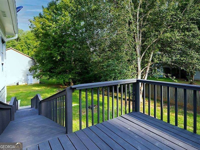 wooden deck featuring a yard