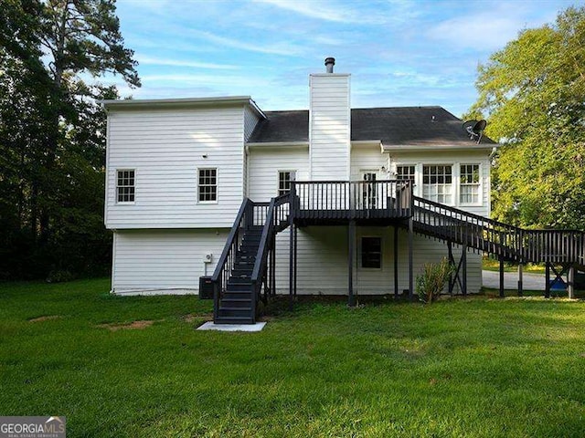 back of house featuring stairs, a wooden deck, a lawn, and a chimney