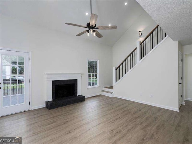 unfurnished living room featuring wood finished floors, baseboards, and a healthy amount of sunlight