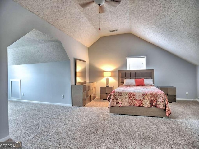 bedroom with visible vents, lofted ceiling, a textured ceiling, carpet floors, and baseboards