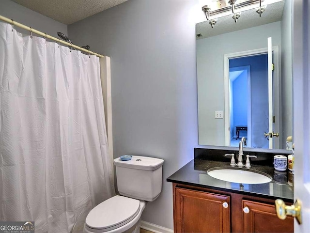 full bath featuring curtained shower, a textured ceiling, toilet, and vanity