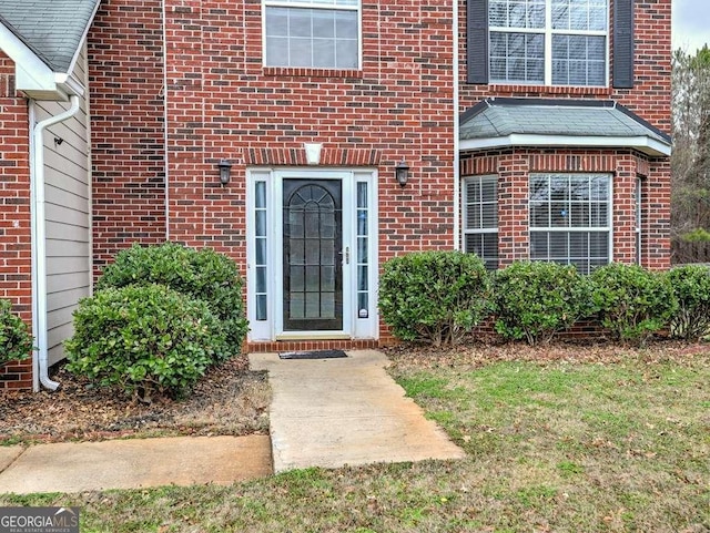 property entrance with brick siding