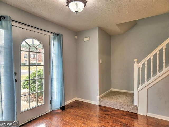 entrance foyer featuring plenty of natural light, baseboards, and wood finished floors