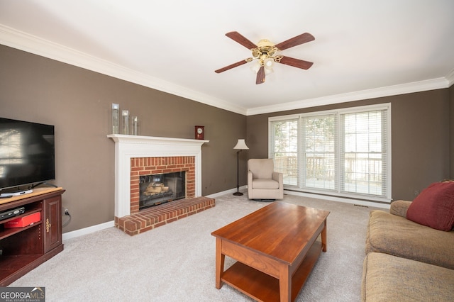 carpeted living room with crown molding, a brick fireplace, baseboards, and ceiling fan