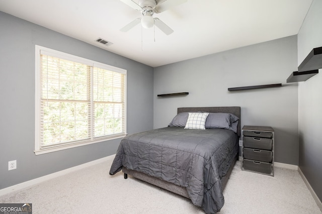 bedroom with visible vents, a ceiling fan, baseboards, and carpet floors