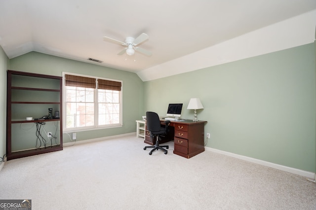 carpeted home office featuring visible vents, baseboards, a ceiling fan, and vaulted ceiling