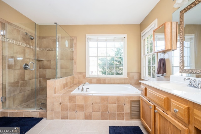 full bathroom featuring visible vents, a shower stall, tile patterned flooring, a bath, and vanity