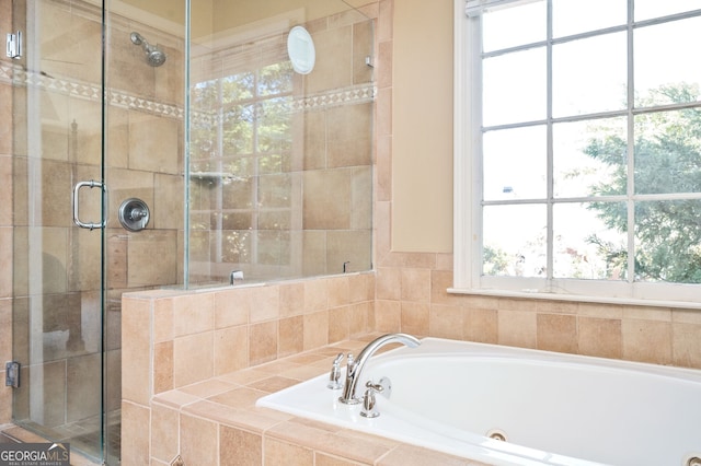 bathroom with a shower stall and a jetted tub