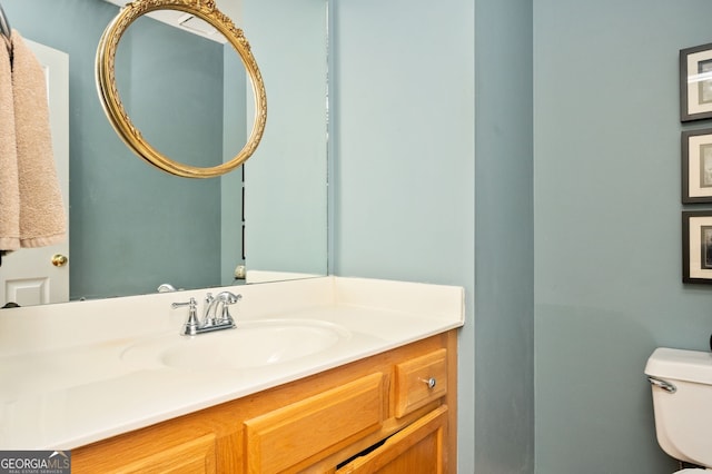 bathroom featuring toilet and vanity