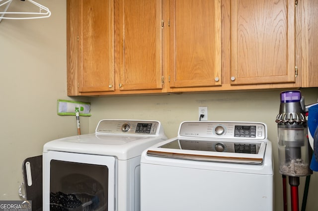 washroom featuring cabinet space and washer and dryer