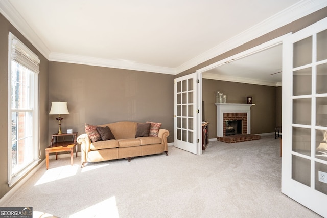 living area featuring baseboards, ornamental molding, french doors, a brick fireplace, and carpet flooring