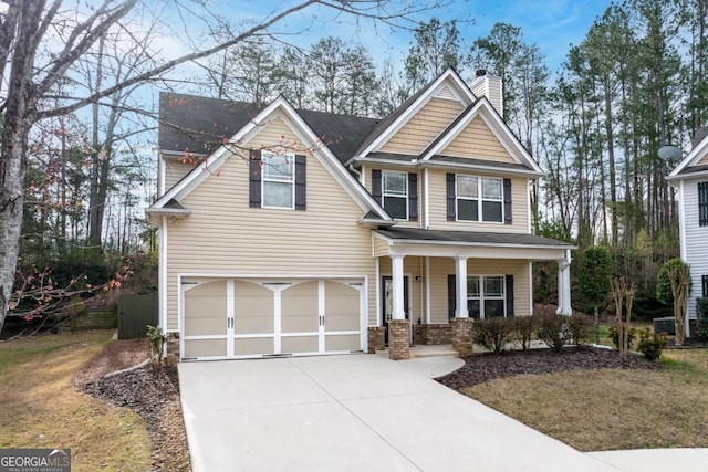 craftsman house with covered porch, concrete driveway, a chimney, and a garage