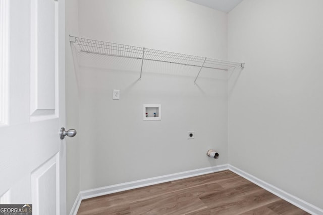 laundry room featuring baseboards, laundry area, hookup for a washing machine, wood finished floors, and electric dryer hookup