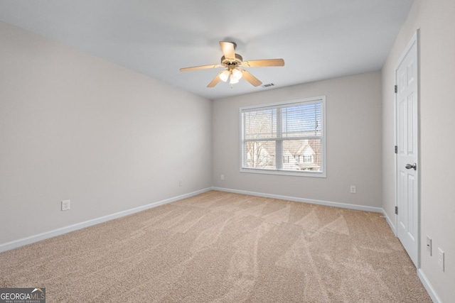 unfurnished bedroom featuring visible vents, light carpet, baseboards, and a ceiling fan