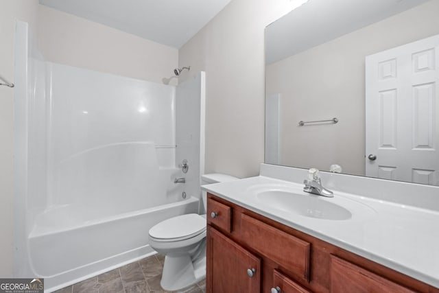 bathroom with bathing tub / shower combination, toilet, and vanity