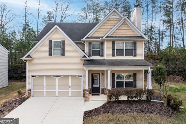 craftsman-style house with a porch, an attached garage, a chimney, and driveway