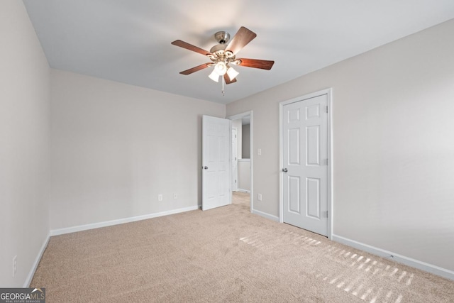 unfurnished bedroom with a ceiling fan, carpet, and baseboards