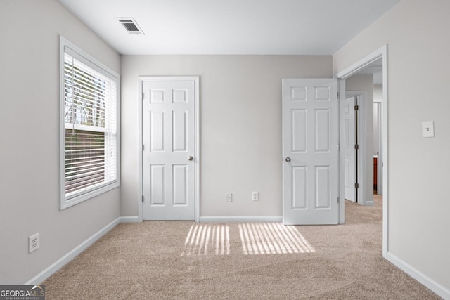 unfurnished bedroom with visible vents, baseboards, and carpet floors