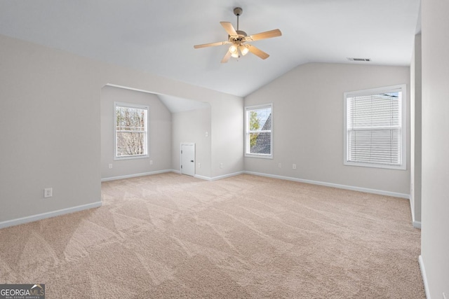 interior space featuring baseboards, visible vents, lofted ceiling, ceiling fan, and carpet flooring