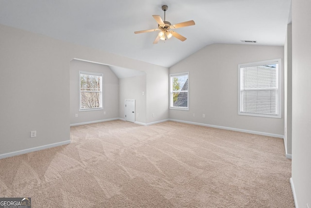 interior space with visible vents, baseboards, carpet flooring, lofted ceiling, and ceiling fan