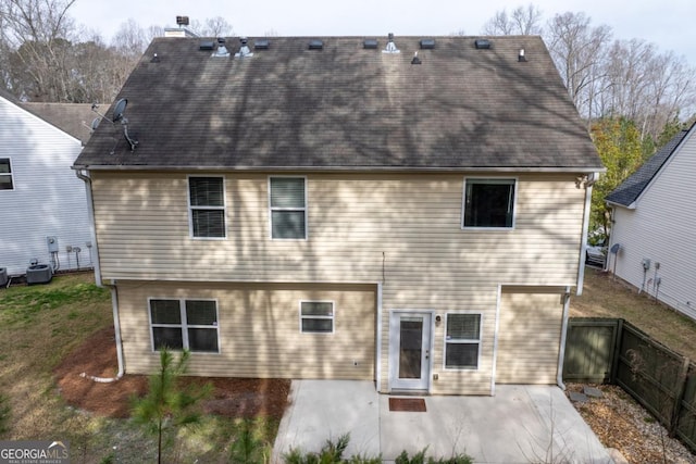 rear view of property with a patio area, central AC unit, and fence