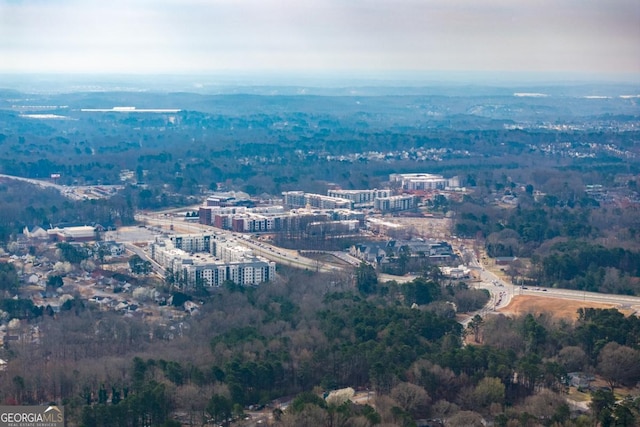 birds eye view of property featuring a forest view