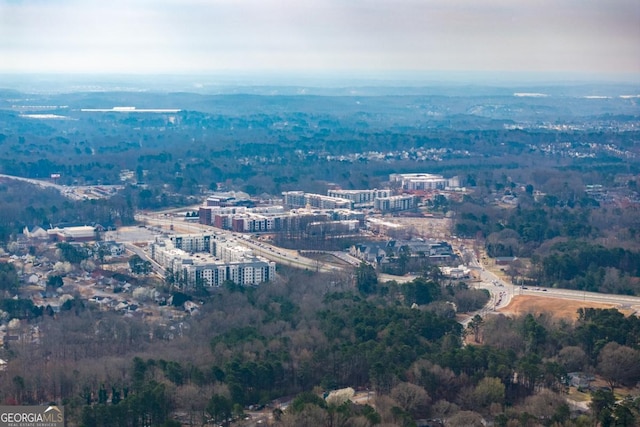 birds eye view of property featuring a view of trees