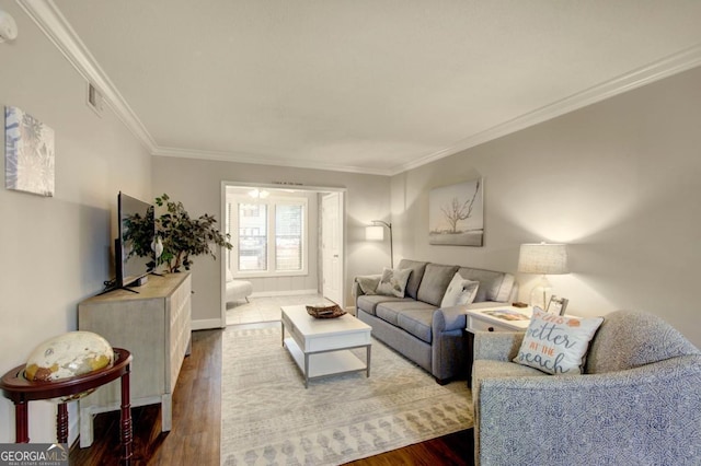 living area with baseboards, visible vents, dark wood-style flooring, and ornamental molding