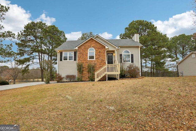 view of front of home featuring a front yard and a chimney