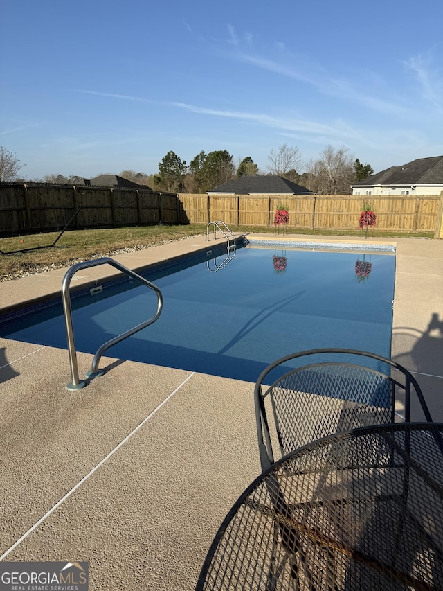 view of pool with a fenced backyard