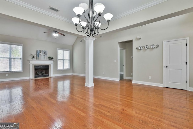 unfurnished living room with visible vents, light wood finished floors, crown molding, and decorative columns