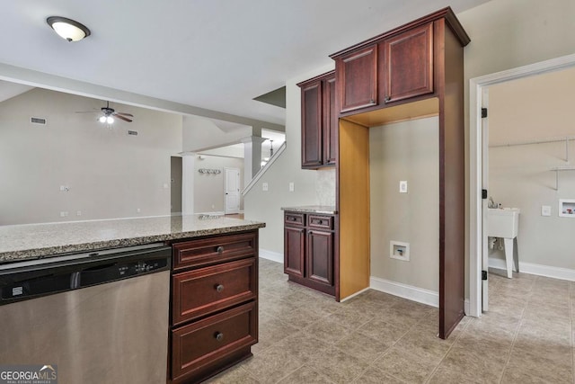 kitchen with baseboards, light stone countertops, ceiling fan, stainless steel dishwasher, and reddish brown cabinets