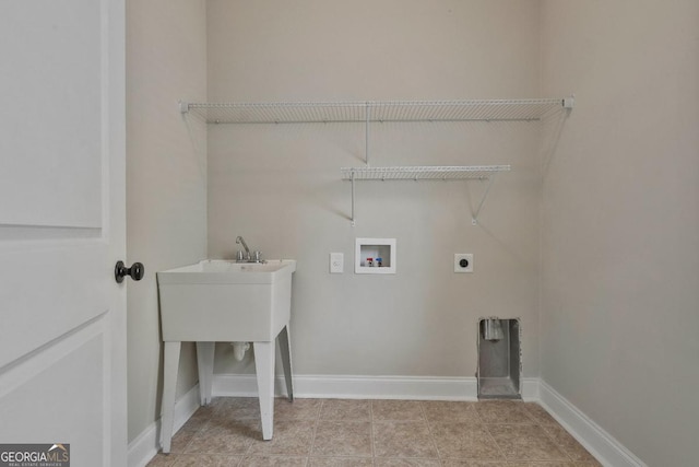 washroom featuring electric dryer hookup, light tile patterned floors, baseboards, hookup for a washing machine, and laundry area