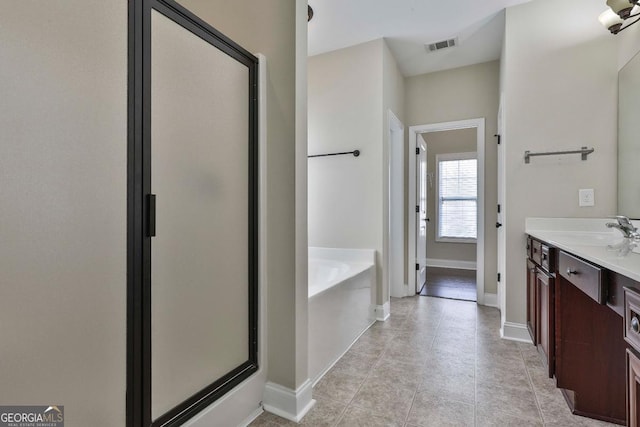 full bath featuring visible vents, a shower stall, baseboards, a bath, and vanity