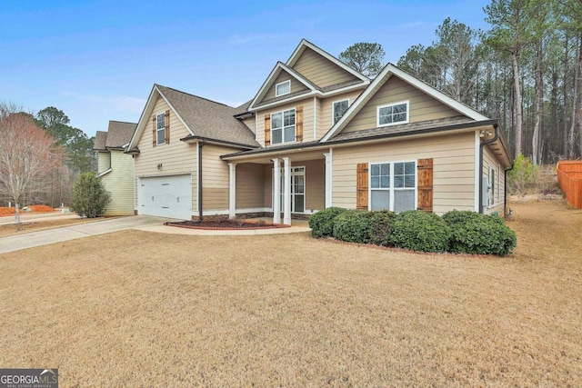 craftsman-style home featuring concrete driveway, an attached garage, and a front yard