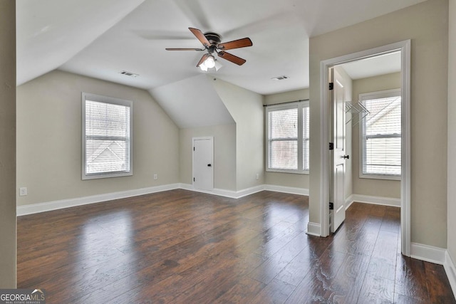 bonus room with visible vents, baseboards, a ceiling fan, and dark wood-style flooring