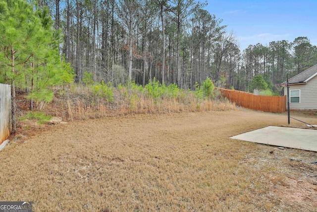 view of yard featuring a patio and fence