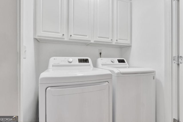 laundry area featuring cabinet space and separate washer and dryer