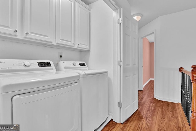 laundry room with wood finished floors, cabinet space, independent washer and dryer, and baseboards