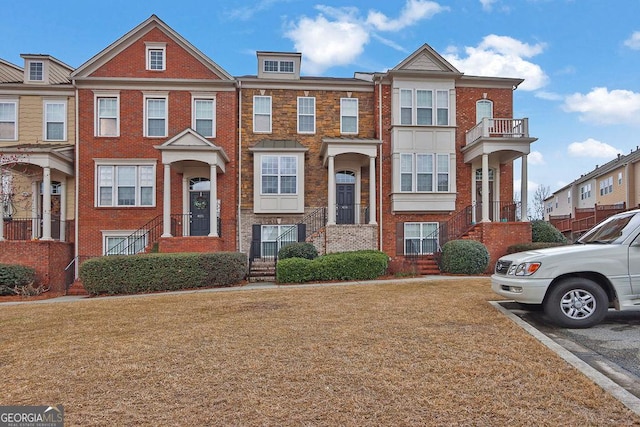 townhome / multi-family property with brick siding