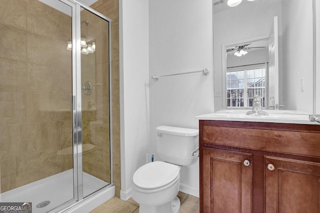 full bath featuring toilet, a stall shower, a ceiling fan, tile patterned flooring, and vanity